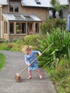 3-year-old Phoebe sweeping the path to our house after her grandmother weeded the swale